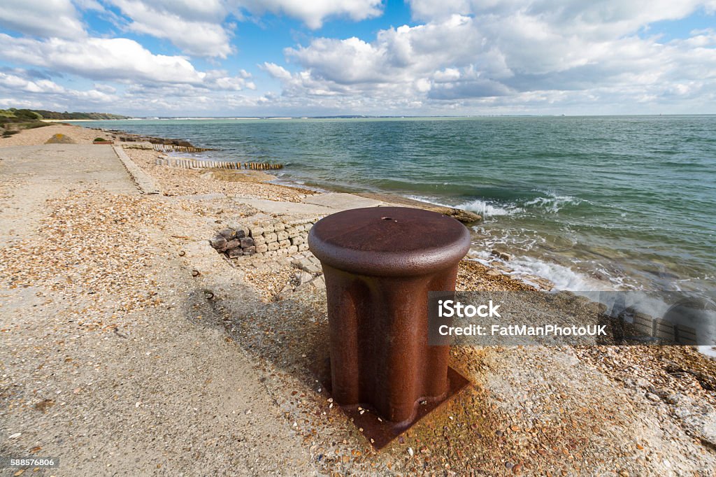 Old bollard for ship. World War II iron bollard for tying up ships. Lepe Country Park, Exbury Southampton, Hampshire, England, United Kingdom Anchor - Vessel Part Stock Photo