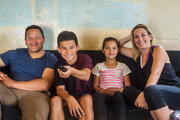Pacific Islander Mixed Race Maori Family Watching Television Together