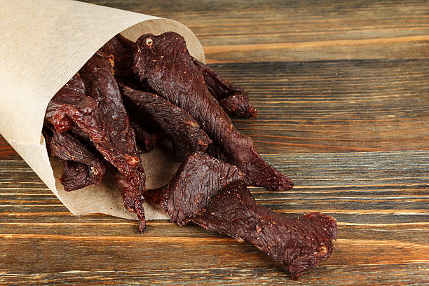 Beef jerky Beef jerky on a wooden board close-up chewy photos stock pictures, royalty-free photos & images