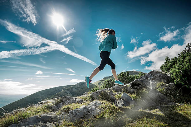istock Female running in mountains under sunlight. 588579566