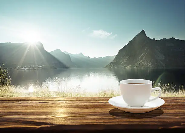 Photo of cup of coffee and sunset in Norway, Lofoten islands