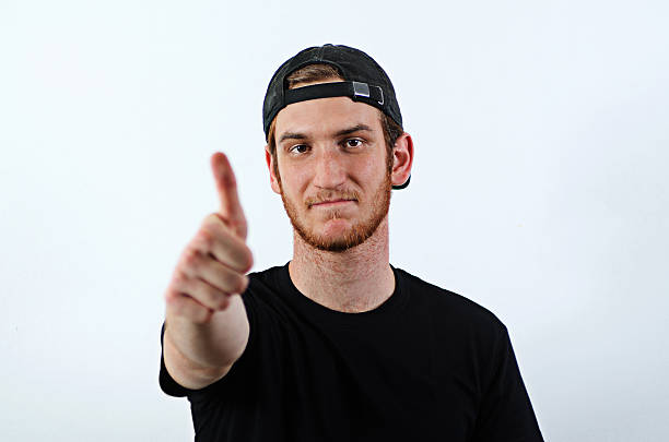 jovem adulto masculino mostra seus polegares para cima - baseball cap men ok thumbs up - fotografias e filmes do acervo
