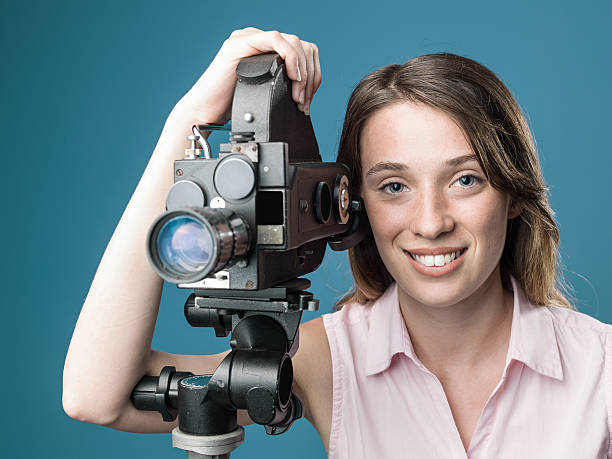 istock Young Film Director Posing With Her Old Fashioned Camera 588585112