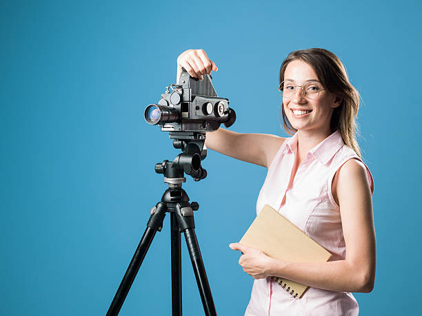 istock Young Film Director Posing With Her Old Fashioned Camera 588585114
