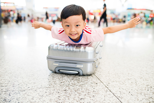 Cute little boy waiting in the airport, child travel 