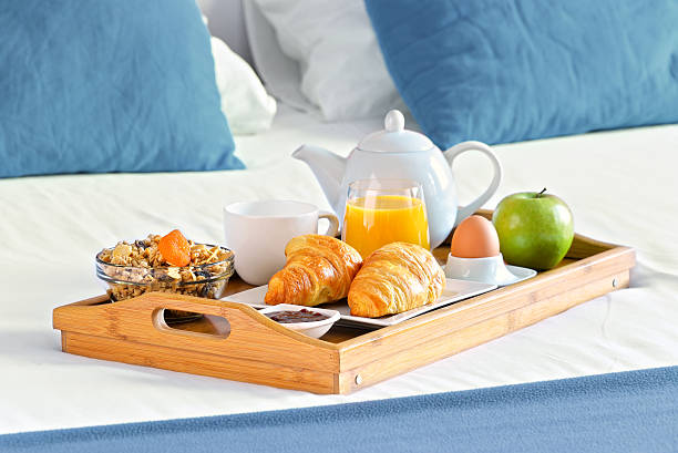 istock Breakfast on tray in bed in hotel room 588586106