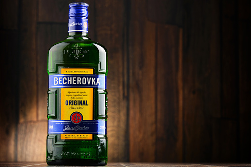 Poznan, Poland - July 28, 2016: Becherovka often used as a digestive aid is a an herbal bitters produced in Karlovy Vary, Czech Rep. by the Jan Becher company. Owned by Pernod Ricard.