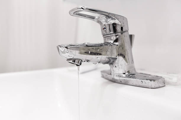 istock Bathroom water faucet with water leak 588587672