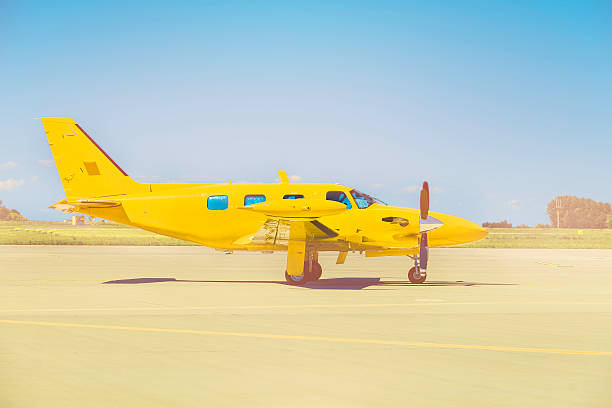 istock Yellow propeller plane parking at the airport 588587734