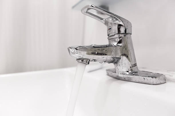 istock Bathroom water faucet with water turn on 588587964