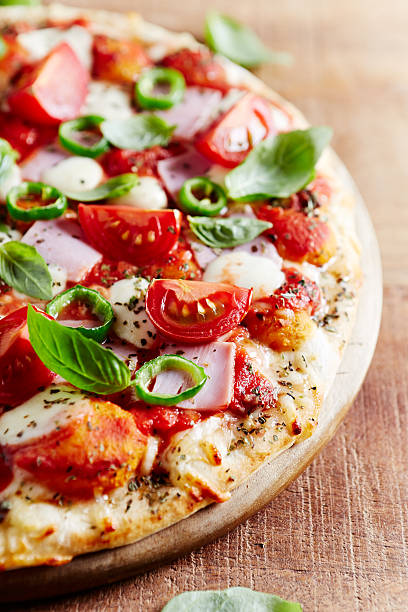 istock Pizza with ham, cherry tomatoes and chili peppers 588588014