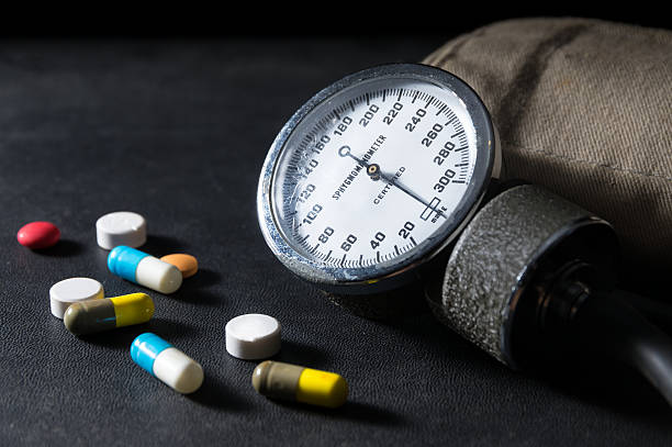 Sphygmomanometer with medicine pills Sphygmomanometer with medicine pills and capsules. blood pressure medication stock pictures, royalty-free photos & images