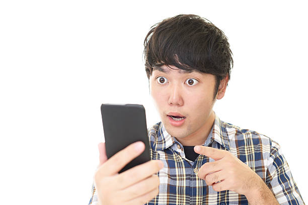 istock Surprised Asian man with a smart phone 588588896