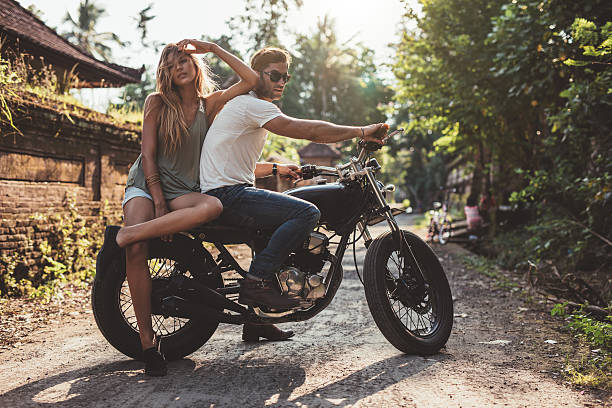 istock Couple hanging out in countryside with motorcycle 588591494