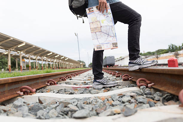 istock woman holding map with backpack at train station 588594190