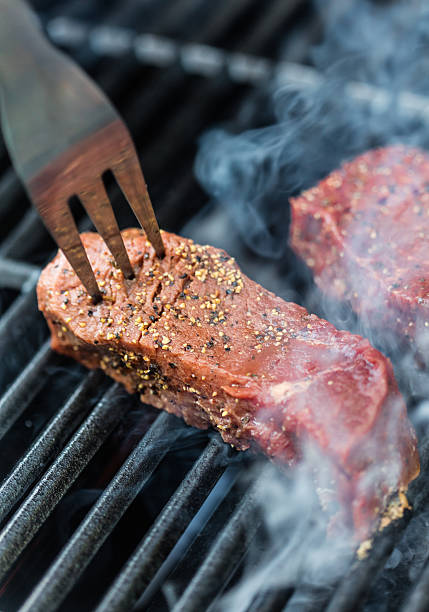 istock Raw sirloin steaks on the bbq 588594454