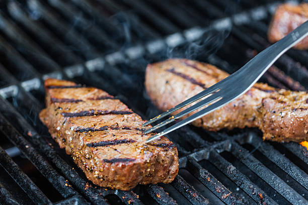 Close-up shot of two sirloin steaks on the bbq.