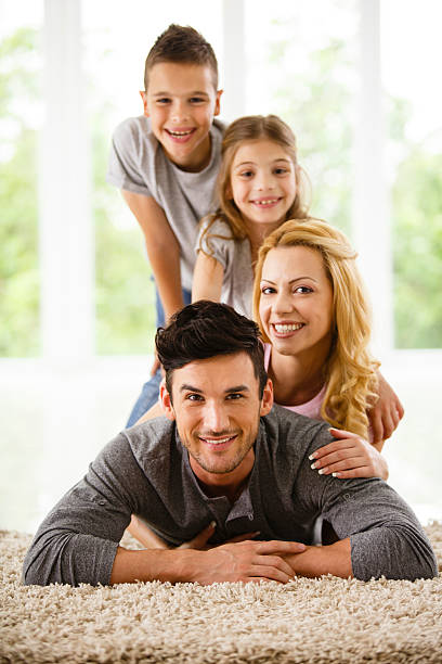 istock Happy family lying down on the floor at home 588594870