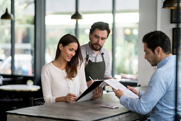 istock Waiter serving a couple at a restaurant 588598100