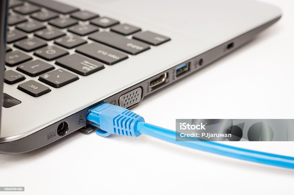 LAN cable is connecting internet to laptop Network Connection Plug Stock Photo