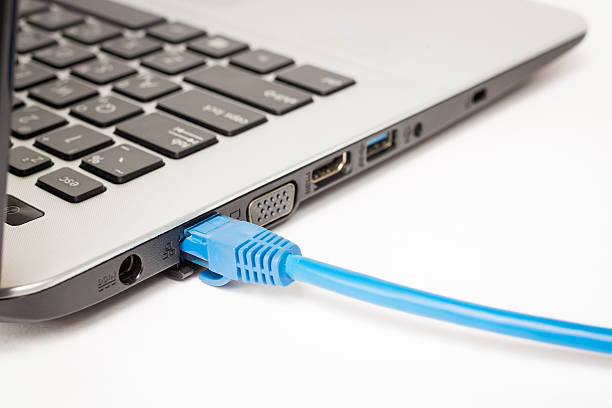 LAN cable is connecting internet to laptop stock photo