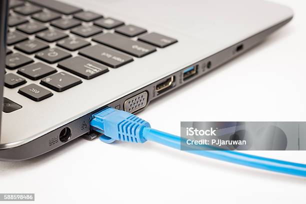 Lan Cable Is Connecting Internet To Laptop Stock Photo - Download Image Now - Network Connection Plug, Laptop, Cable