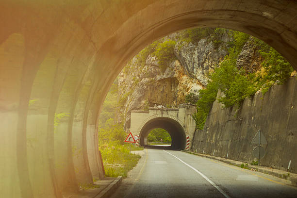 Road with tunnel and sunlight Road with tunnel and sunlight single yellow line sunlight usa utah stock pictures, royalty-free photos & images