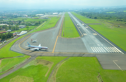 San Jose, Costa Rica - May 10, 2014: Aerial view of runway at Juan Santamaria International Airport on May 10, 2014 in San Jose, the capital of Costa Rica. This airport is the primary airport in the country
