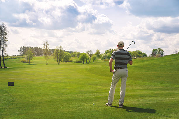 istock male golfer standing at fairway on golf course 588601326