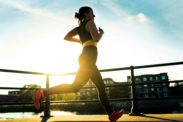 istock woman running at sunset 588601344