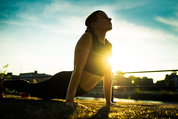 istock woman exercising at sunset 588601538