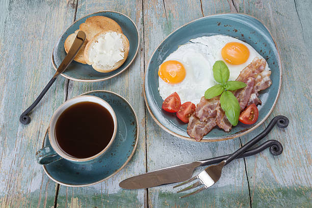 istock Fried eggs,  bacon, tomato, toast and a cup of coffee 588601562