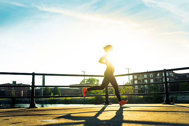 istock woman running at sunset 588601798