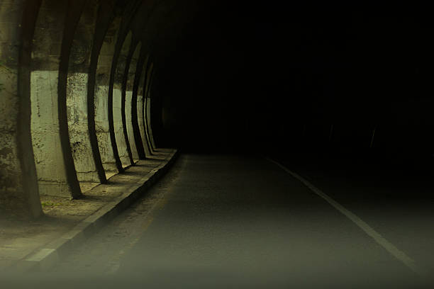 Road with tunnel and sunlight Road with tunnel and sunlight single yellow line sunlight usa utah stock pictures, royalty-free photos & images