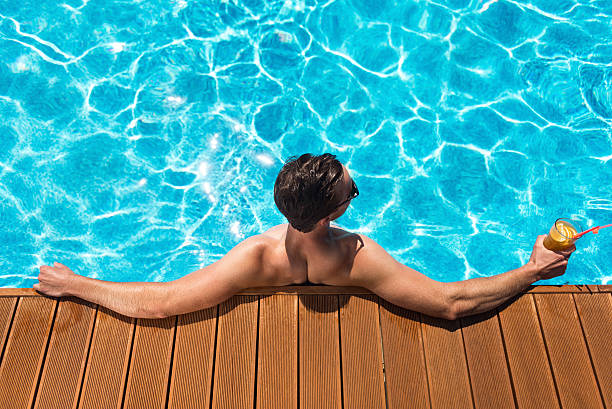 istock Pleasant man resting in the swimming pool 588603004