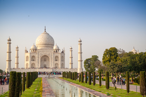 The magnificent Taj Mahal, situated in the city of Agra, and its flow of tourists on a sunny Spring day.