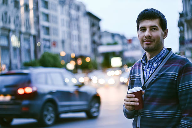 istock Young business man smiling with coffee outdoors 588603444