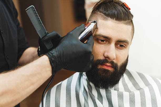 istock Man with dark hair doing a haircut 588603908