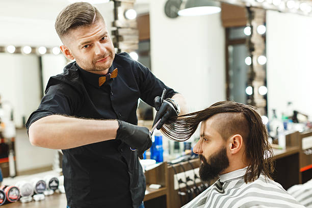 istock Man with dark hair doing a haircut 588604734