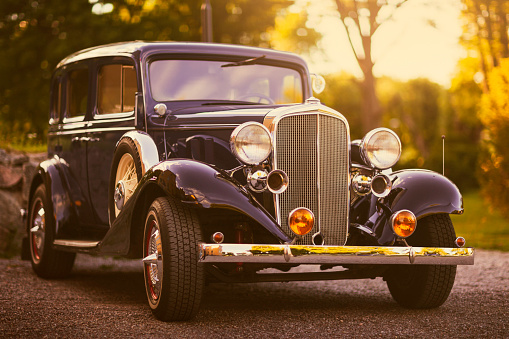 An elegant 1930s station wagon in evening sunlight.