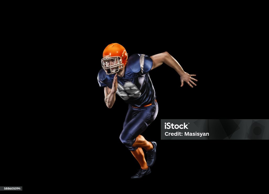 Professional american football player in action isolated on the black Professional american football player in action isolated on the black background American Football Player Stock Photo