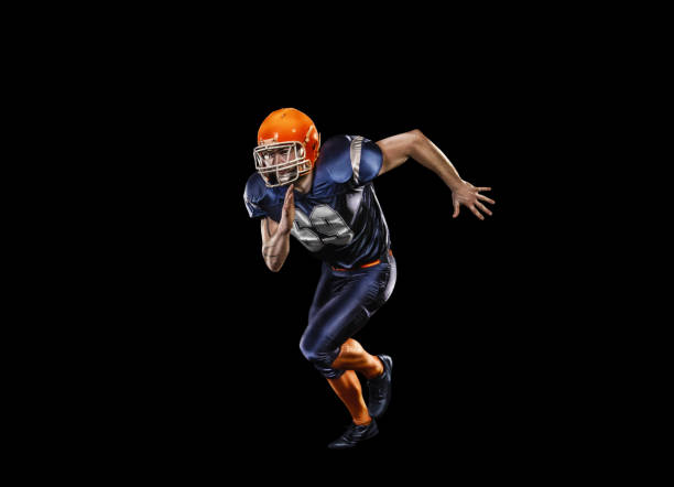 professional american football player in action isolated on the black - football player american football sport determination imagens e fotografias de stock