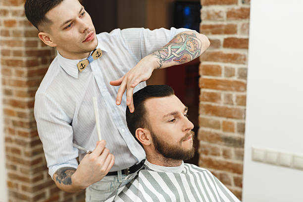 istock Man with dark hair doing a haircut 588605664