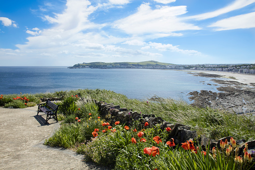 A comfortable seat and flowers in a park overlooking Douglas Bay Isle of Man British Isles