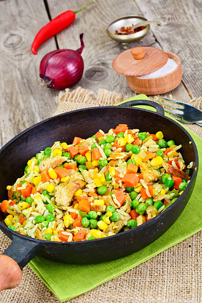 istock Risotto with Vegetables, Carrots, Peas and Chicken 588606744