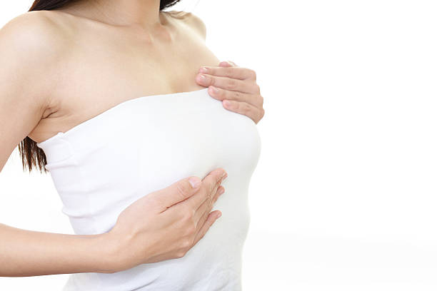 乳房ケアをしている女性 - breast ストックフォトと画像