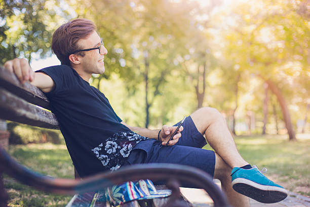 istock Young man smiling at the park 588607302
