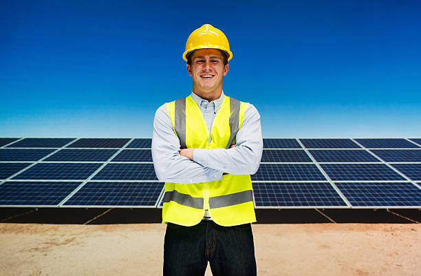 istock Smiling solar worker standing with arms crossed 588608288