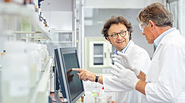 Scientists working on computer in a lab stock photo