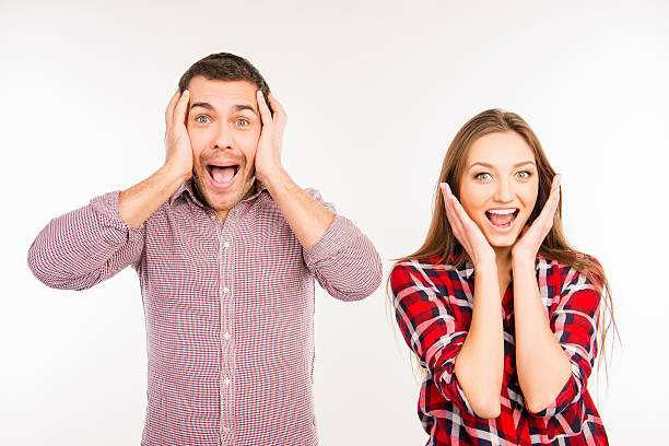 istock Pretty funny cheerful couple showing surprise 588610926